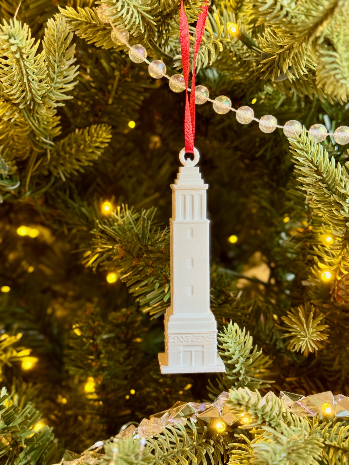 University of Alabama ornament of Denny Chimes on a Christmas tree.