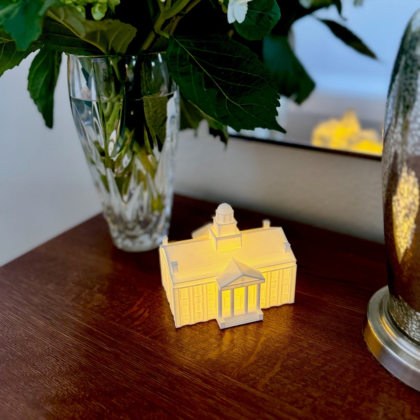 The University of Iowa night light representing Old Capitol, shown on a side table.