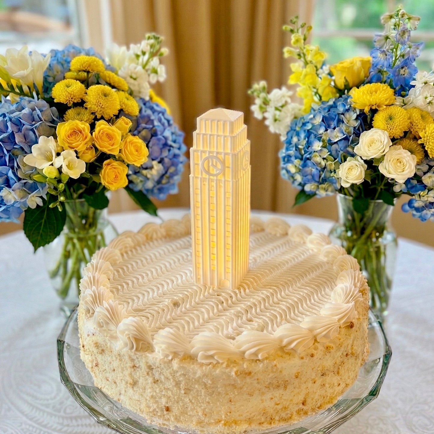 The University of Michigan cake topper light, designed as a replica of the Burton Tower and shown on a graduation cake or groom's cake of a Wolverine's fan.