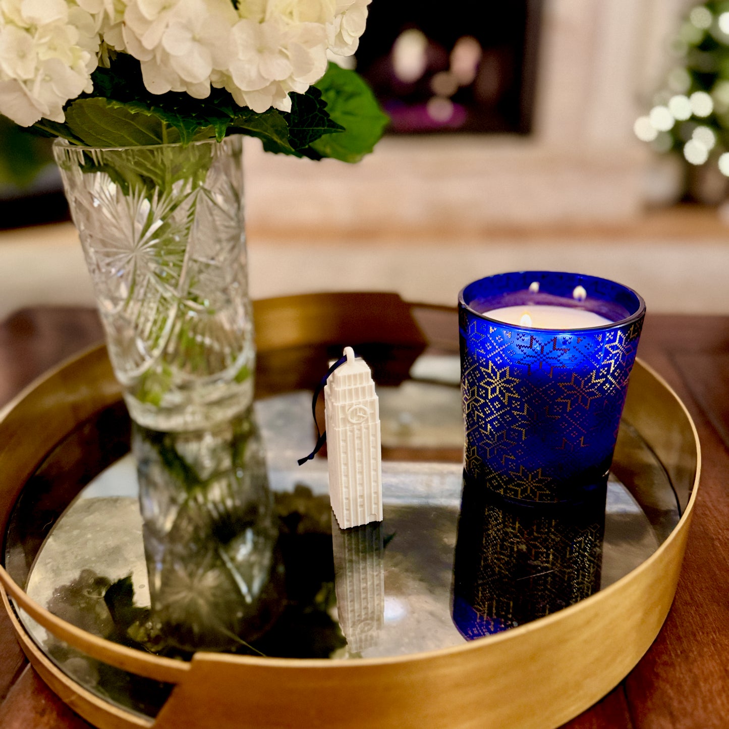The University of Michigan Christmas ornament, shown next to holiday decorations in school colors.