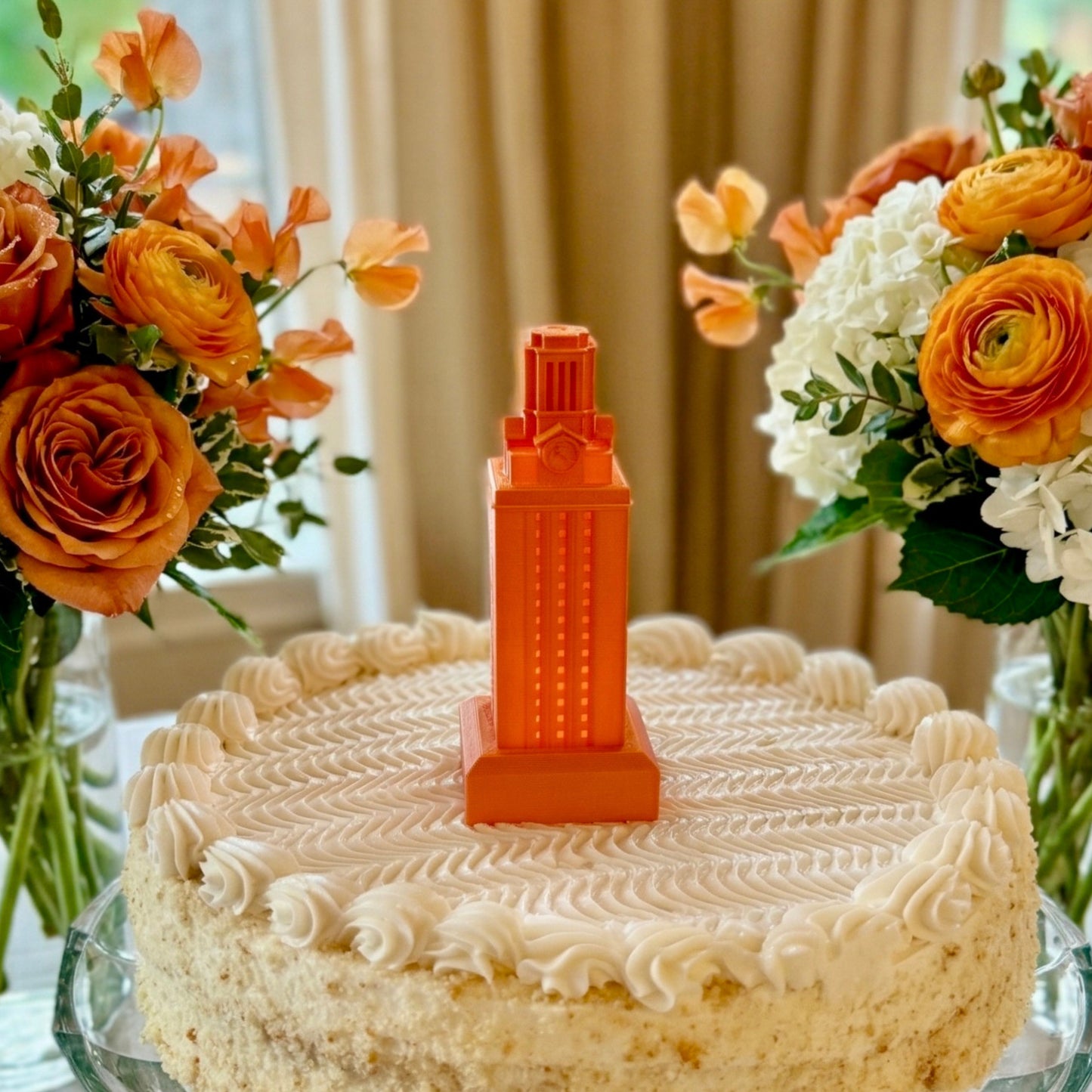 The larger UT Tower light in burnt orange, shown on a graduation cake.
