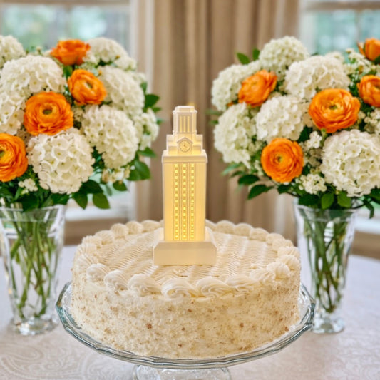 The UT Tower cake topper shown on top of a groom's cake or a graduation cake for a Longhorn alumni.