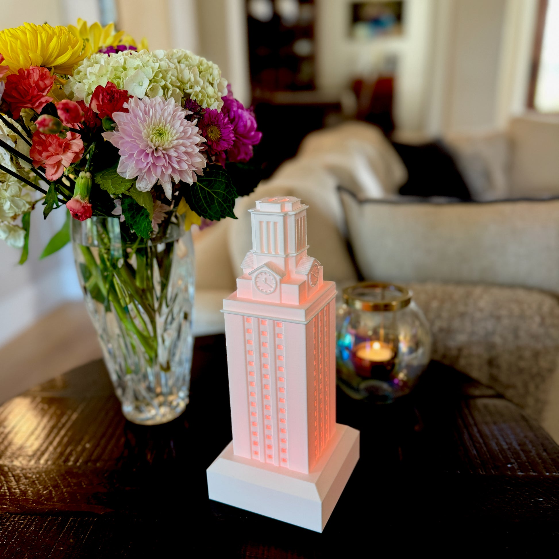 University of Texas home decor item, designed as a light modeled after the UT Tower and shown on a living room side table.