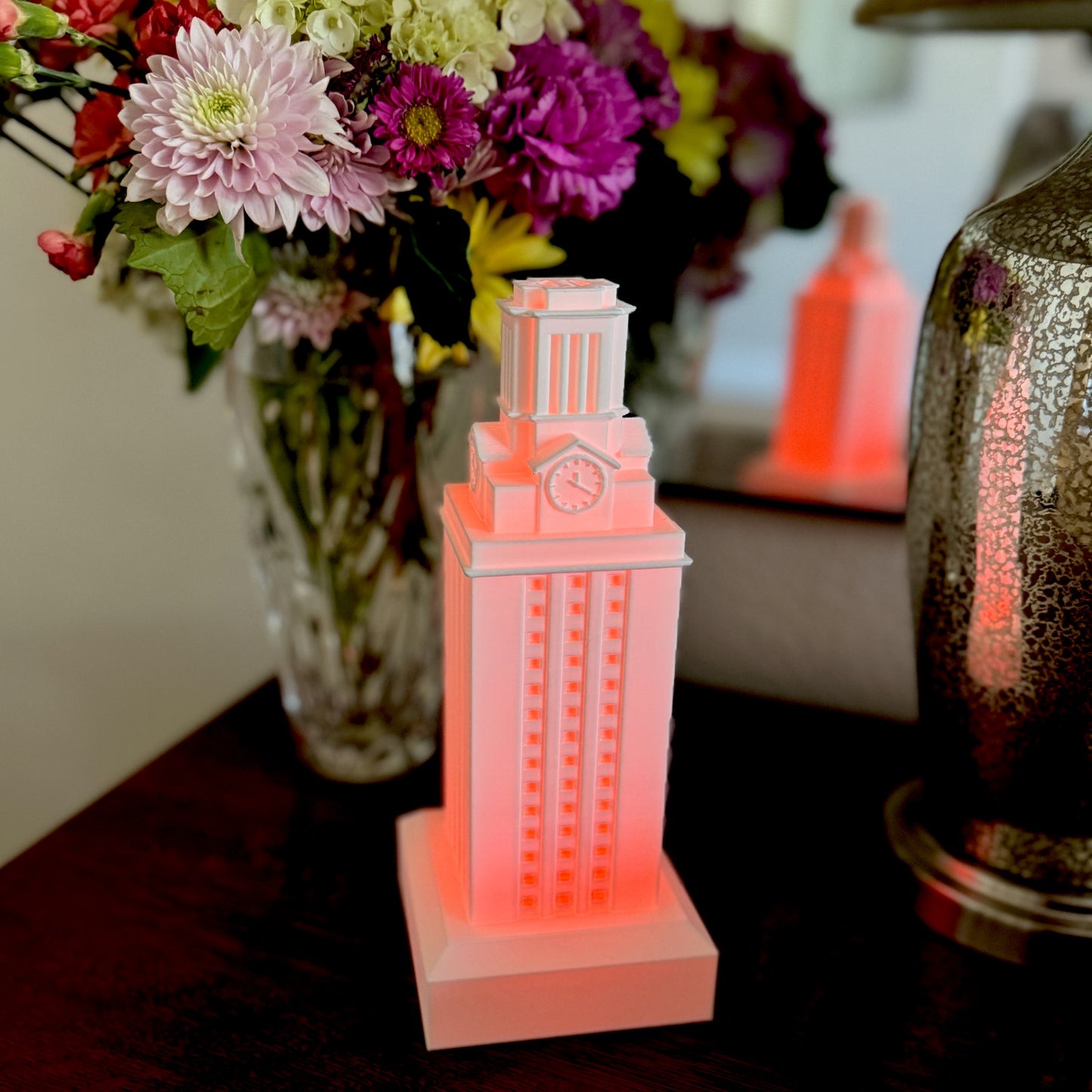 The University of Texas graduation gift (a UT Tower lamp) used as dorm decor and shown on a bedroom side table.