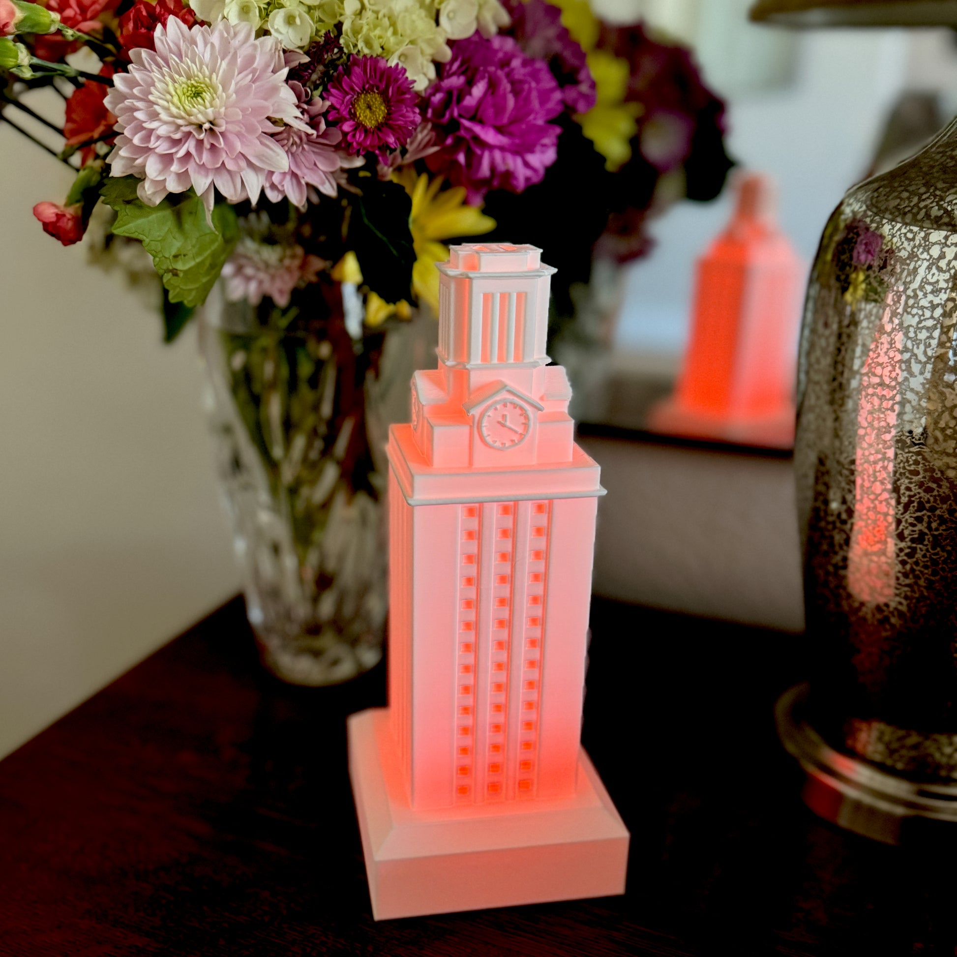 The University of Texas graduation gift (a UT Tower lamp) used as dorm decor and shown on a bedroom side table.