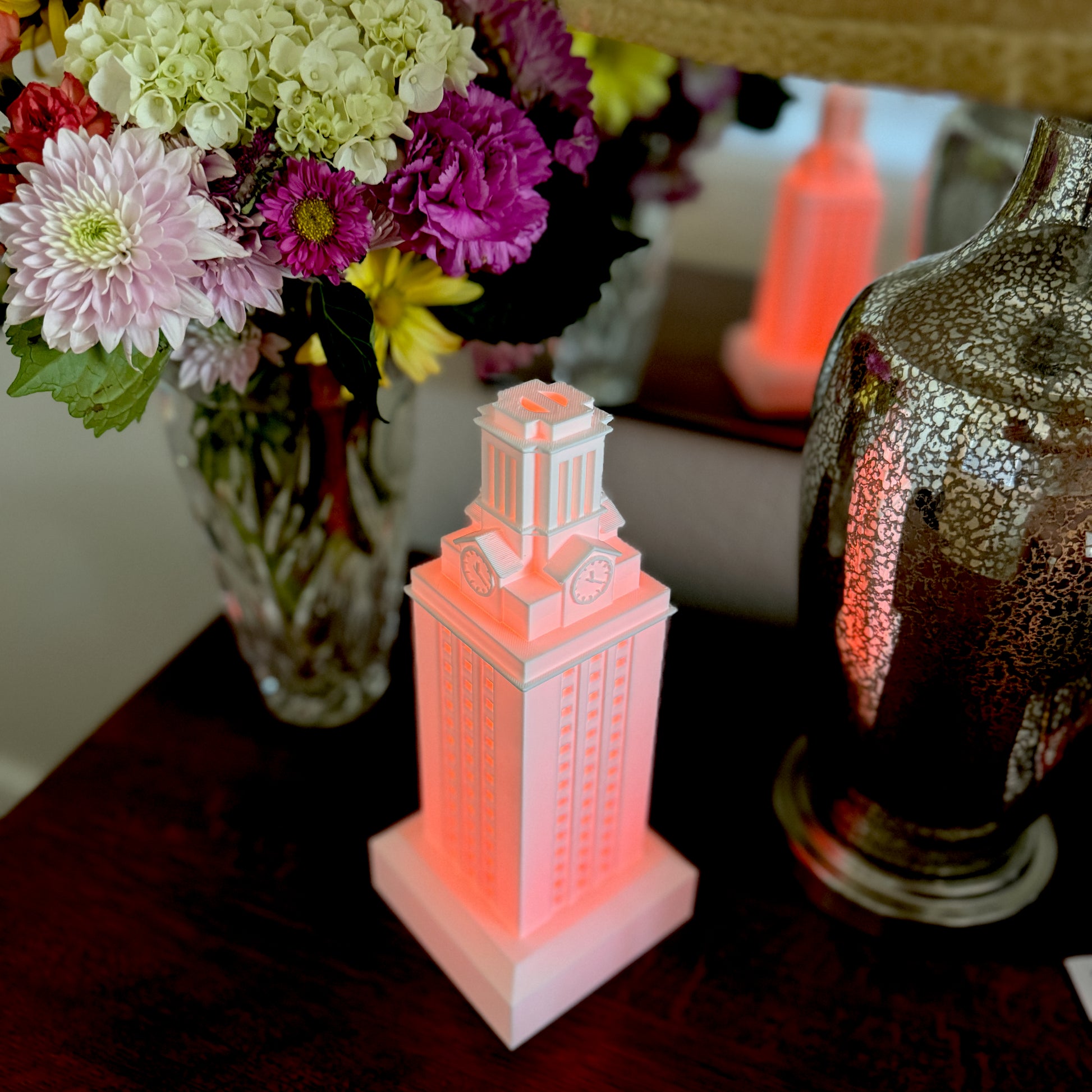 The UT Austin graduation gift, a lamp modeled after the UT Tower with a burnt orange light for UT Longhorns.