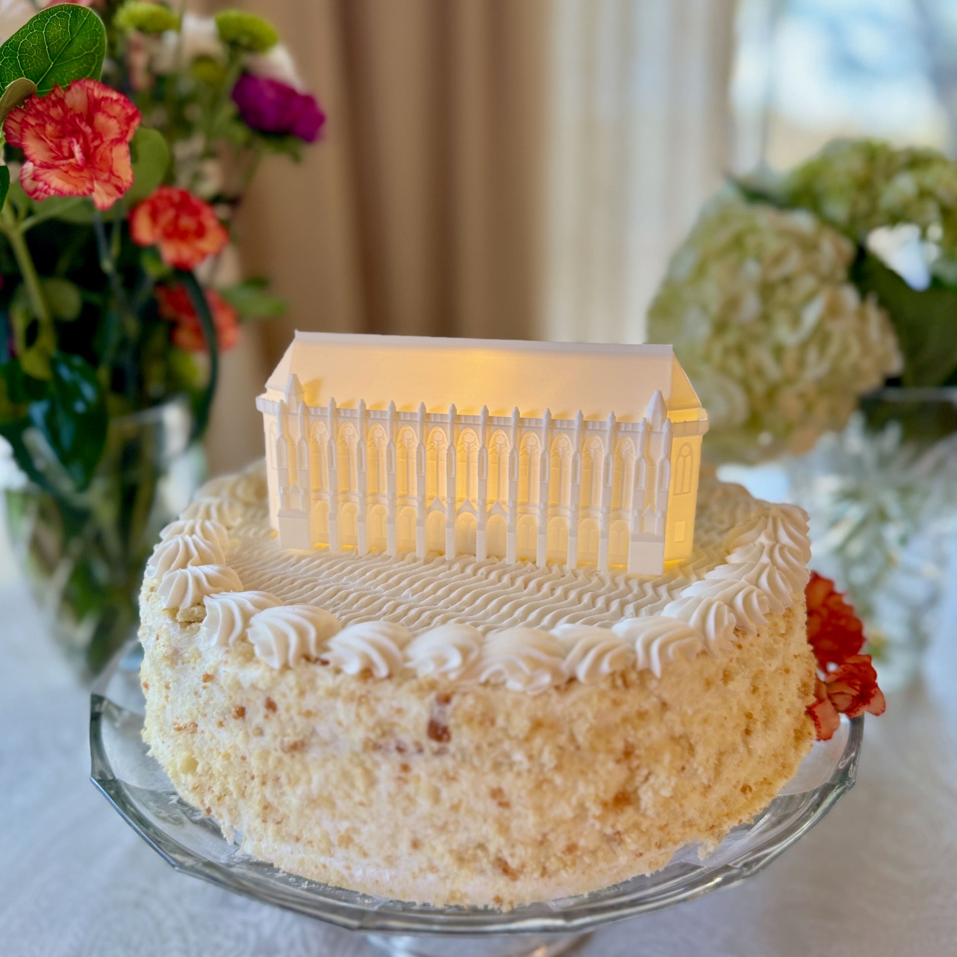 The lighted cake topper of the Suzallo Library at the University of Washington, shown on a UW graduation cake.