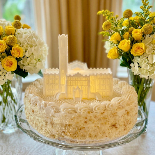 The Vanderbilt cake topper with an LED light, designed as the Kirkland Hall building shown on a graduation cake for Vandy alumni.