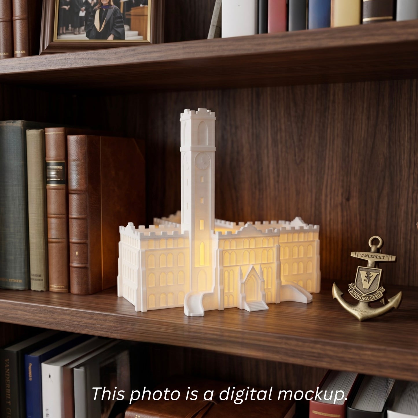 A glowing white 3D-printed model of Vanderbilt's Kirkland Hall sitting on a wooden bookshelf next to law books and a brass Vanderbilt anchor.