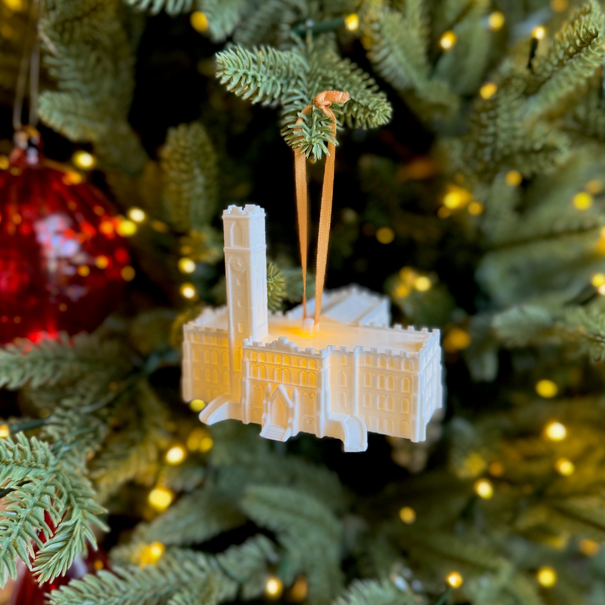 The Vanderbilt ornament depicting Kirkland Hall, shown on a Christmas tree.