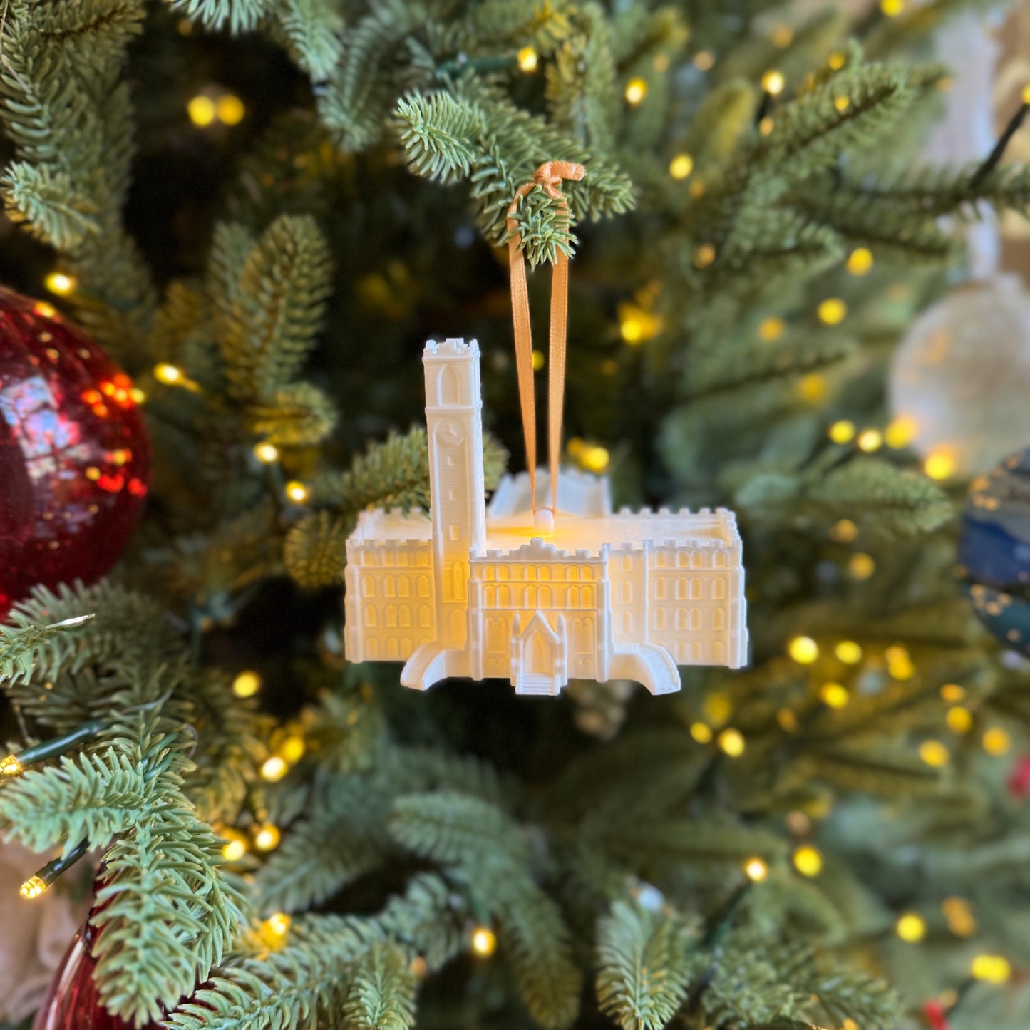 The Vanderbilt University ornament, shown on a Christmas tree and designed as a replica of Kirkland Hall.