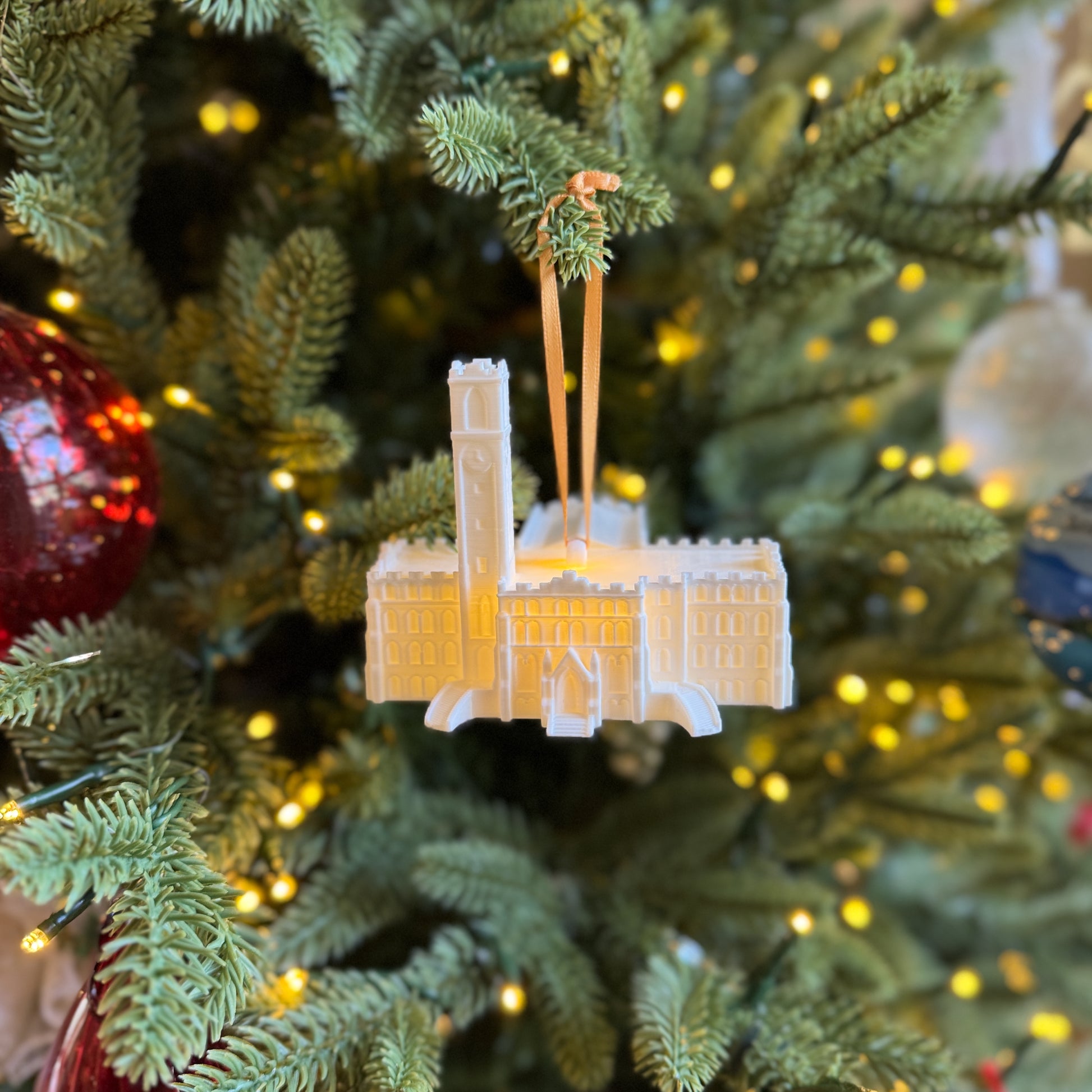 The Vanderbilt University ornament, shown on a Christmas tree and designed as a replica of Kirkland Hall.