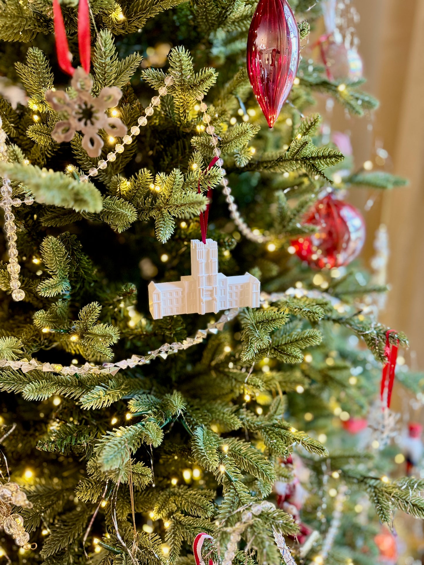 A Virginia Tech tree decorated with a Burruss Hall ornament.