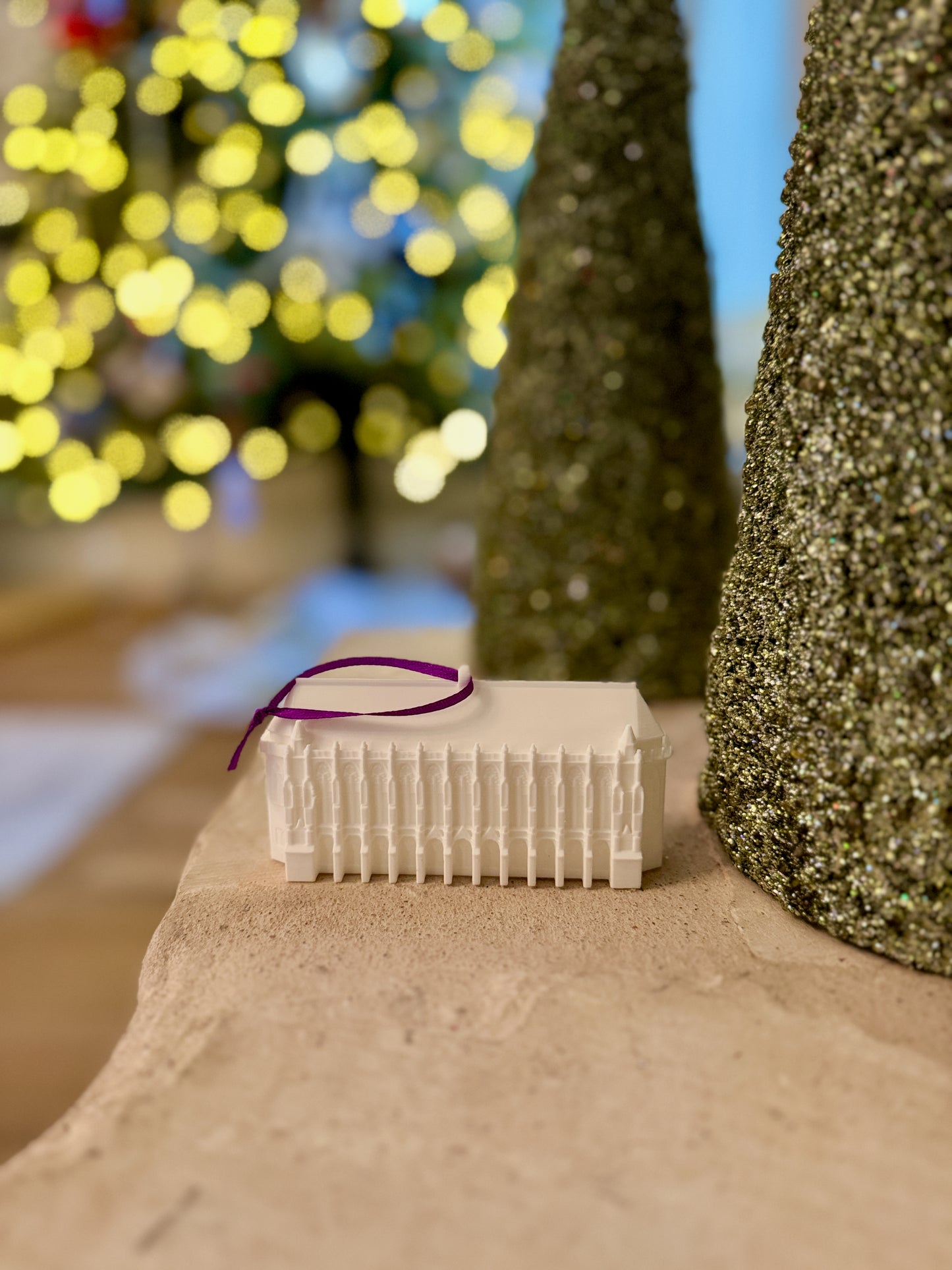 The University of Washington ornament designed as the Suzzallo library and shown in a home decorated for Christmas.