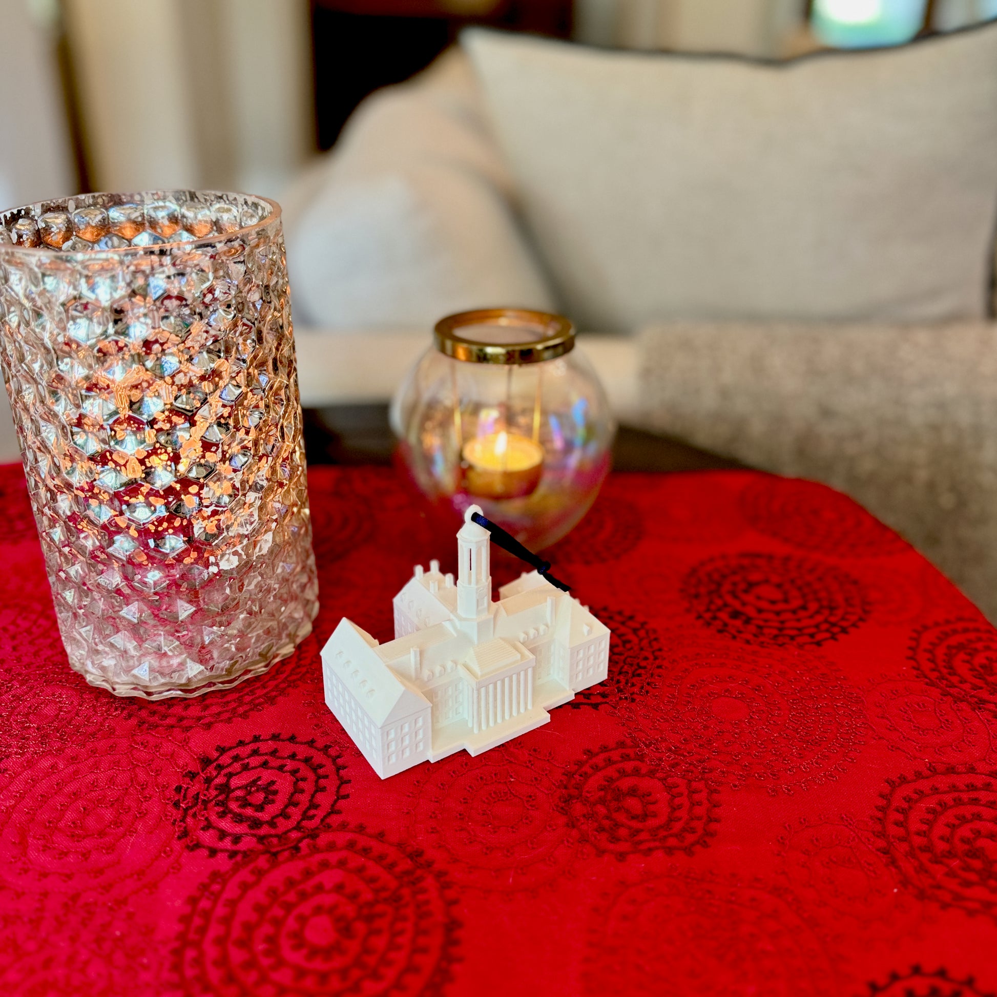 The college ornament for Penn State, shown in a home decorated for Christmas and designed as a replica of the Old Main building on campus.