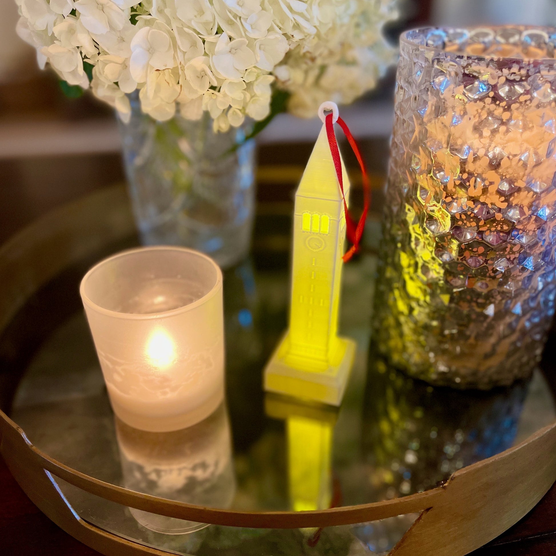 The Cornell Christmas ornament, shown with a light.