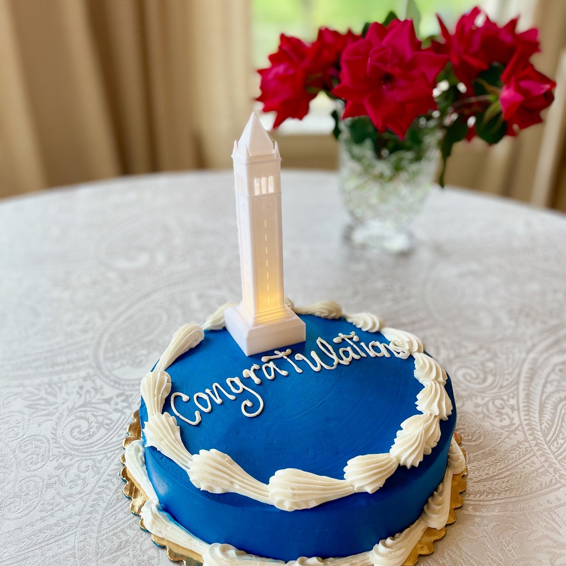 The lighted Berkeley cake topper figurine, a replica of the Berkley Campanile, used on a Berkeley graduation cake.