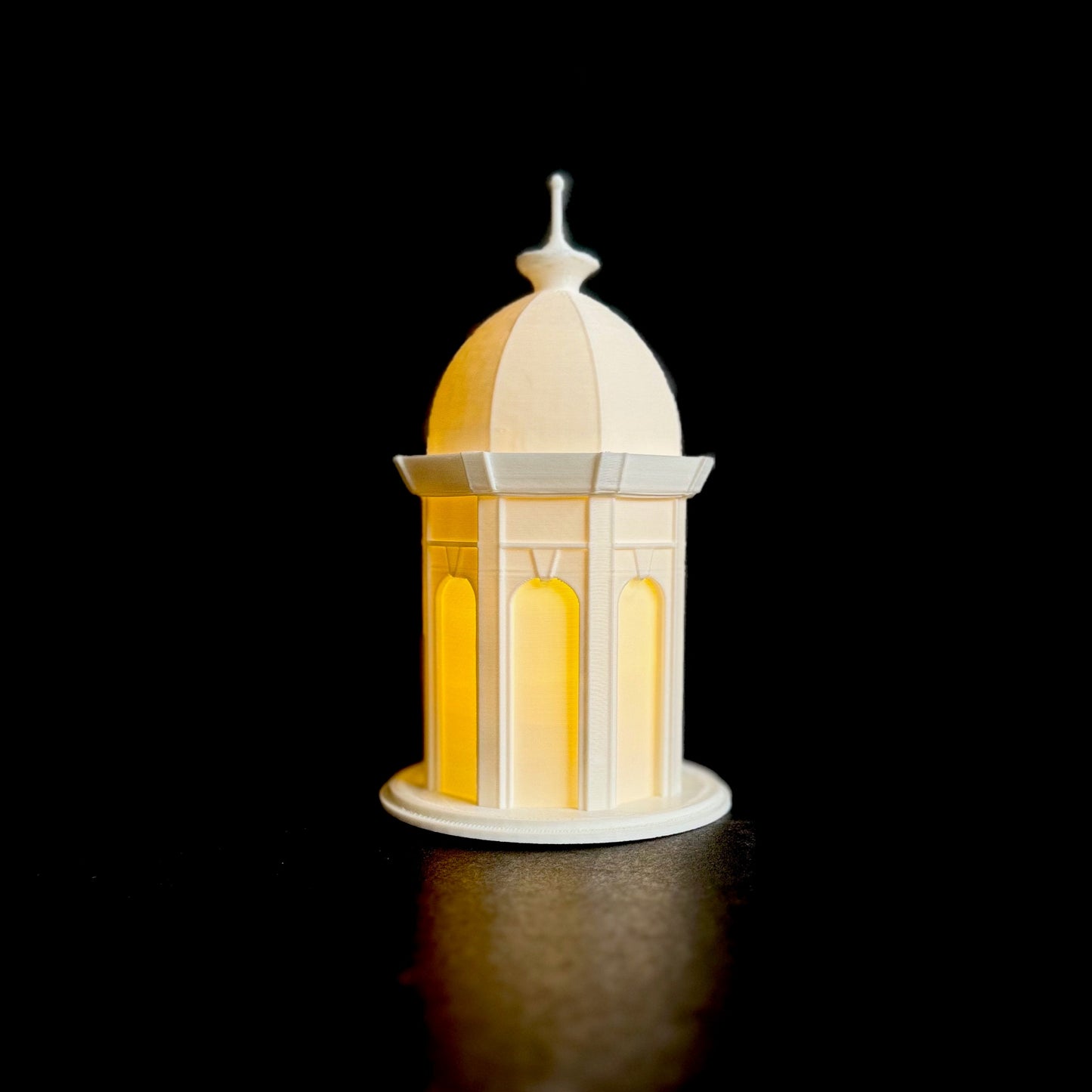 The lighted ECU Cupola figurine, shown against a black background.