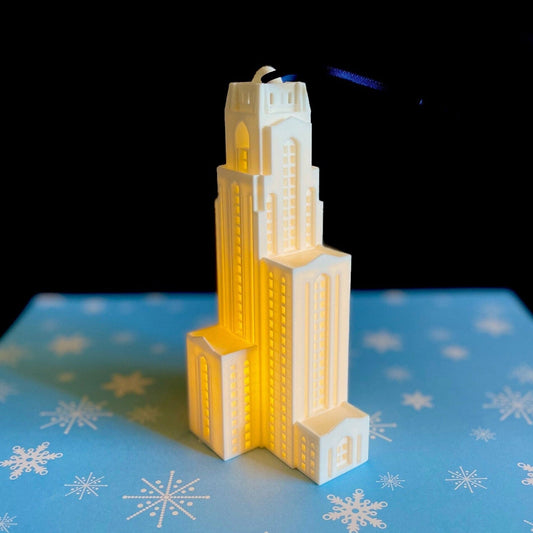 The University of Pittsburg ornament, shown against a blue background.