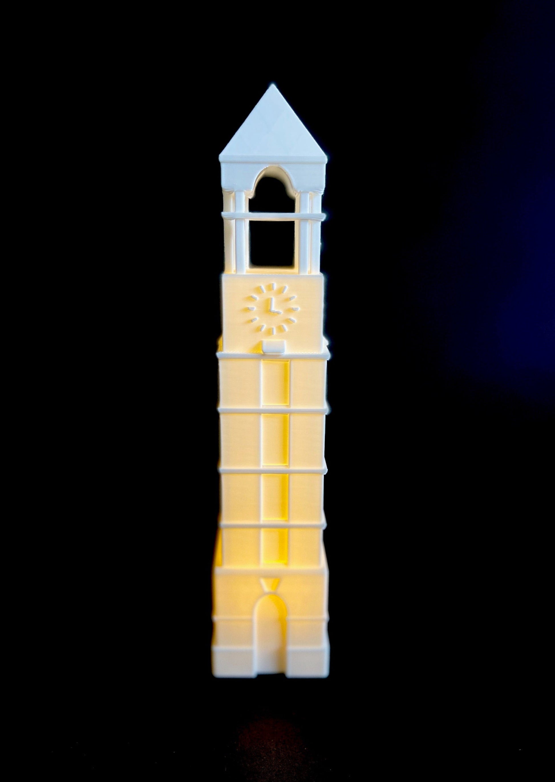 The Purdue Bell Tower figurine, shown against a black background.