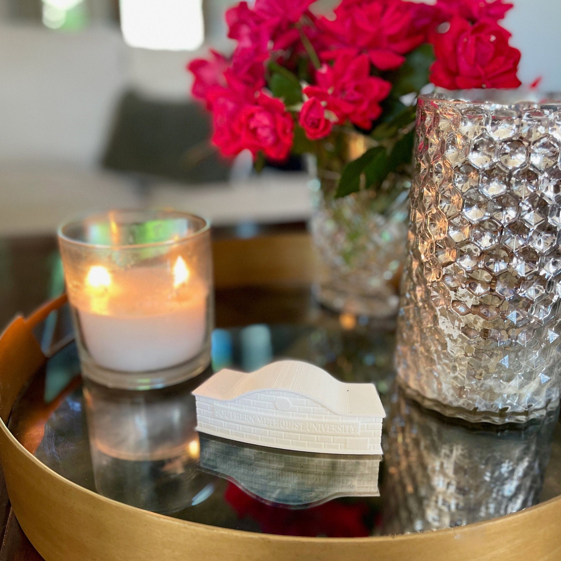 The SMU entrance sign figurine, shown on a living room tray.