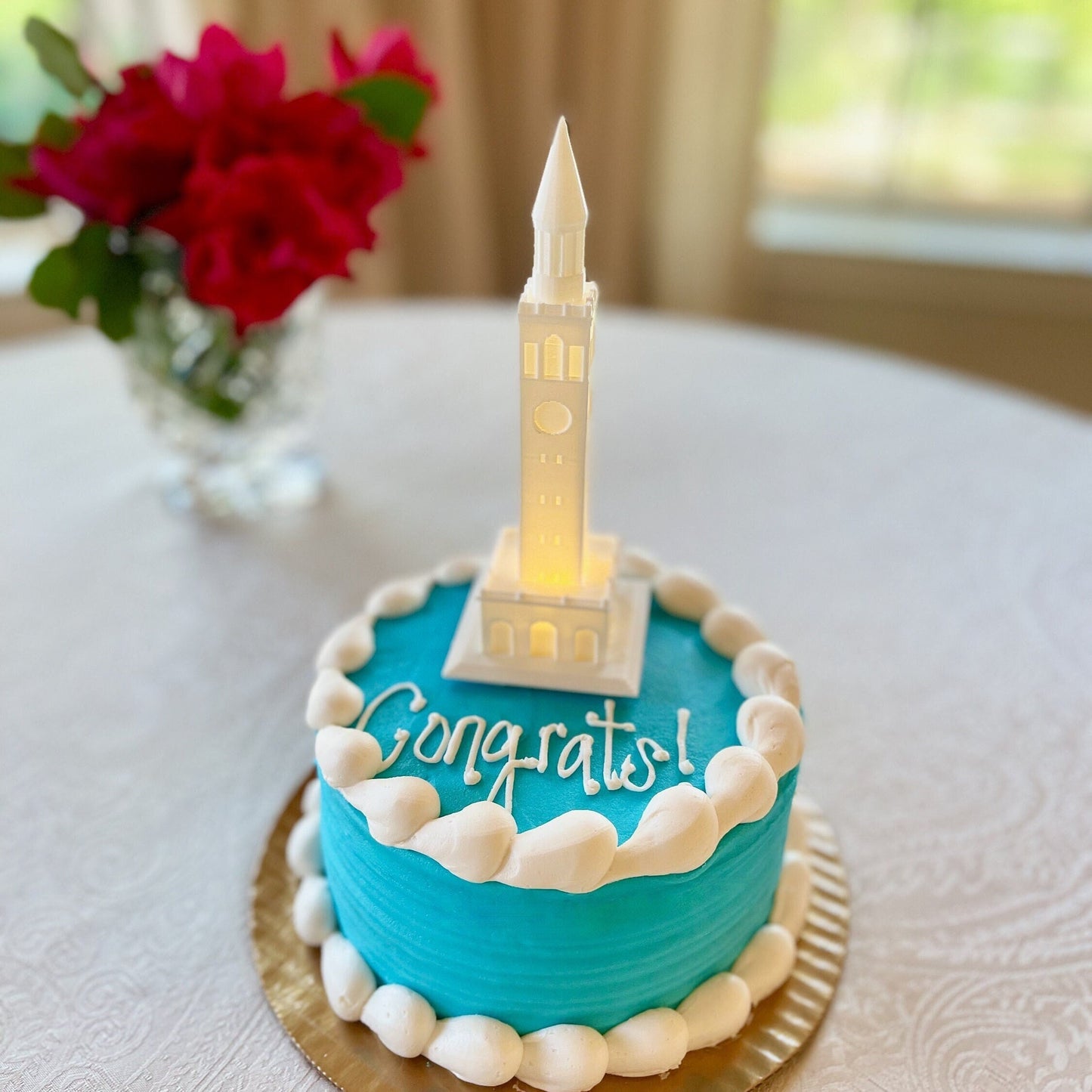 The lighted UNC cake topper, shown on a UNC graduation cake.