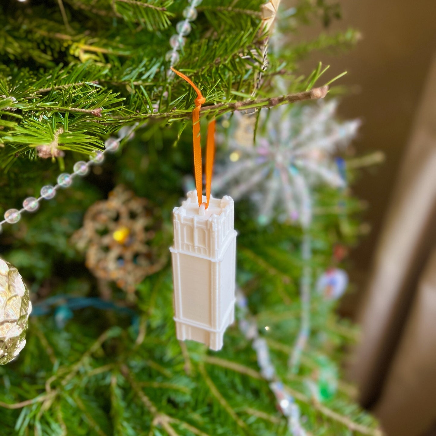 The University of Florida ornament, shown on a Christmas tree in school colors.